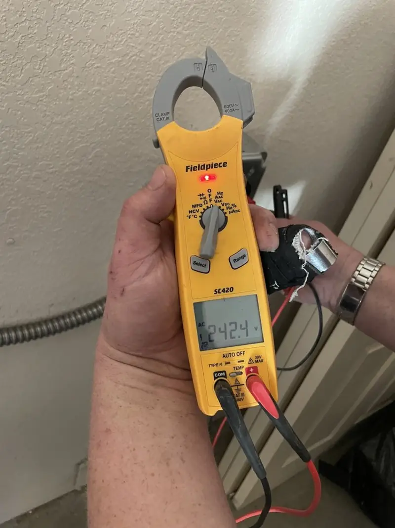 Voltage testing with clamp meter during Ceiling Fan Installation in Swansea